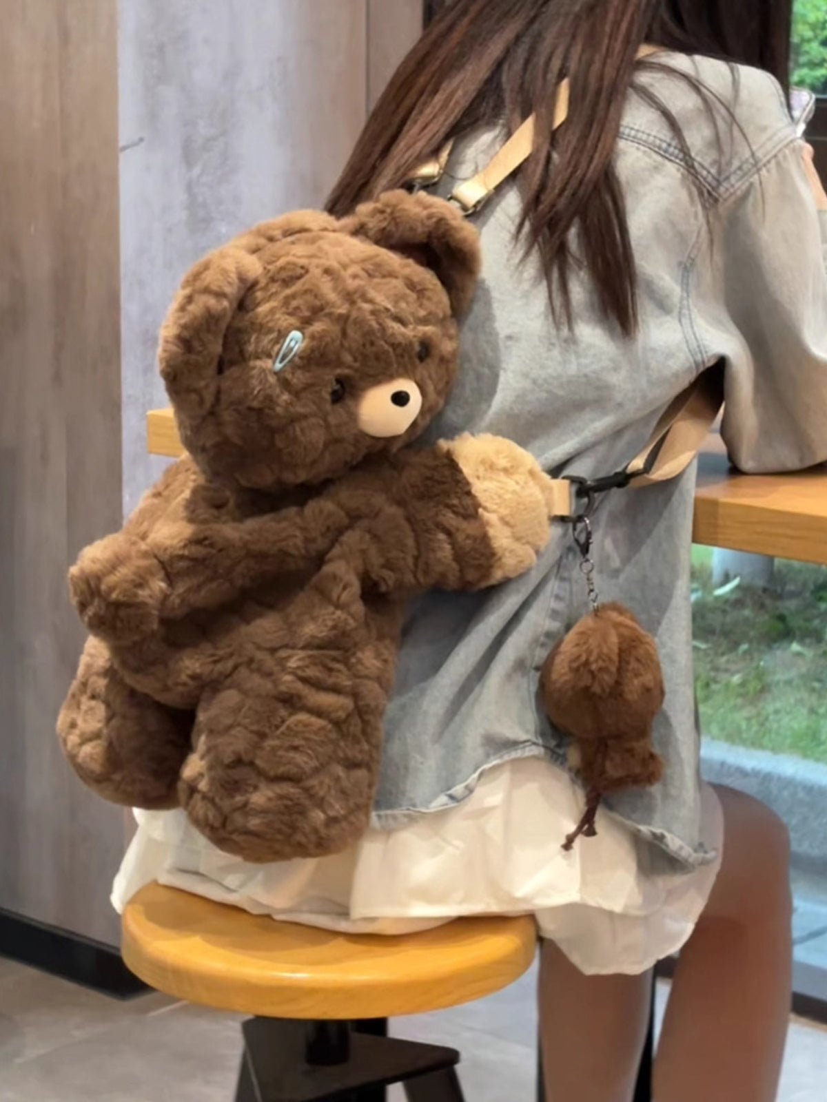 Dark brown plush teddy bear backpack top handle close up