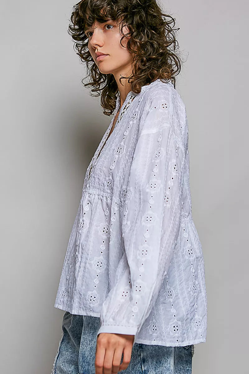 Eyelet and lacework texture close up on the cotton blouse