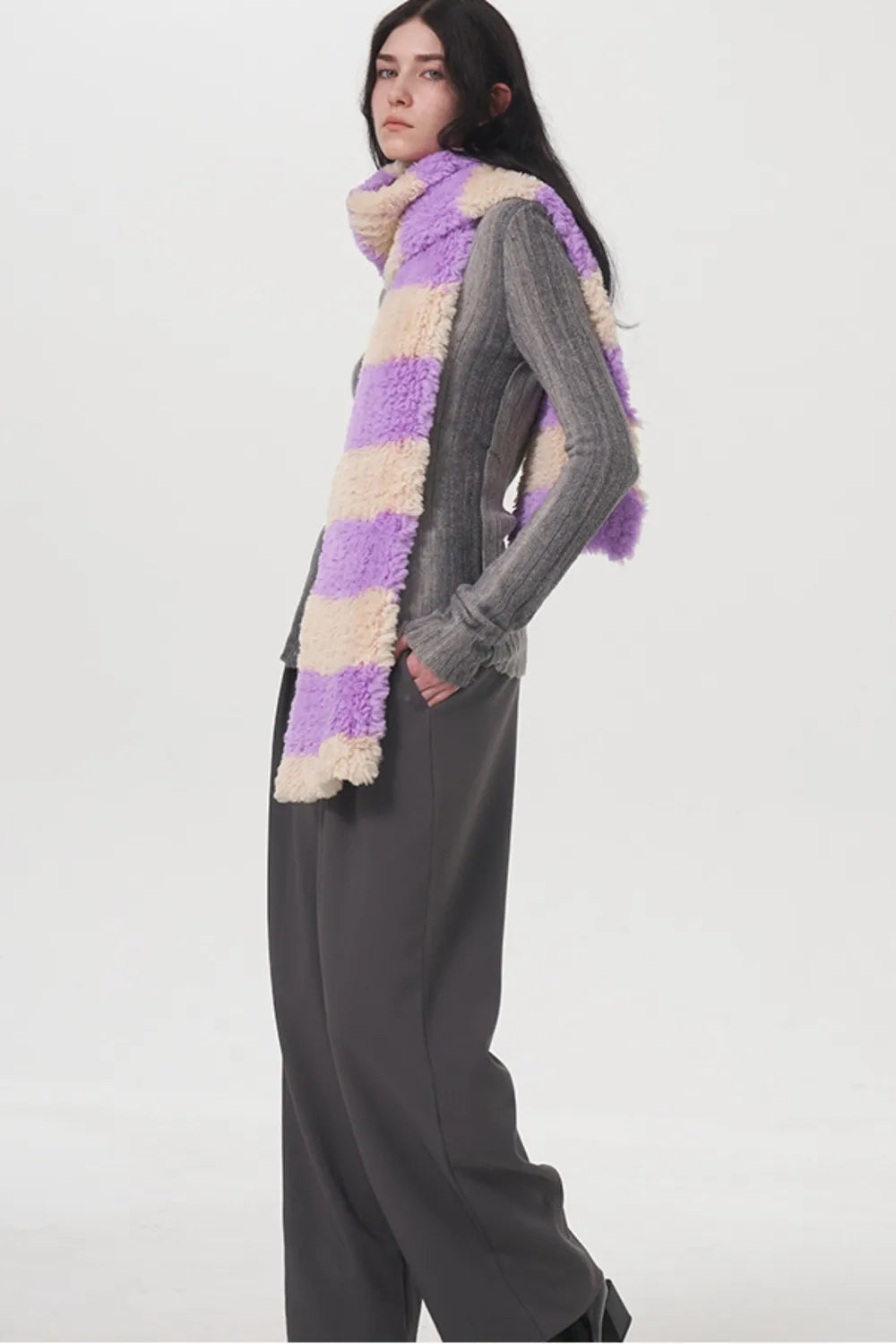 Fuzzy striped scarf styled with a coat