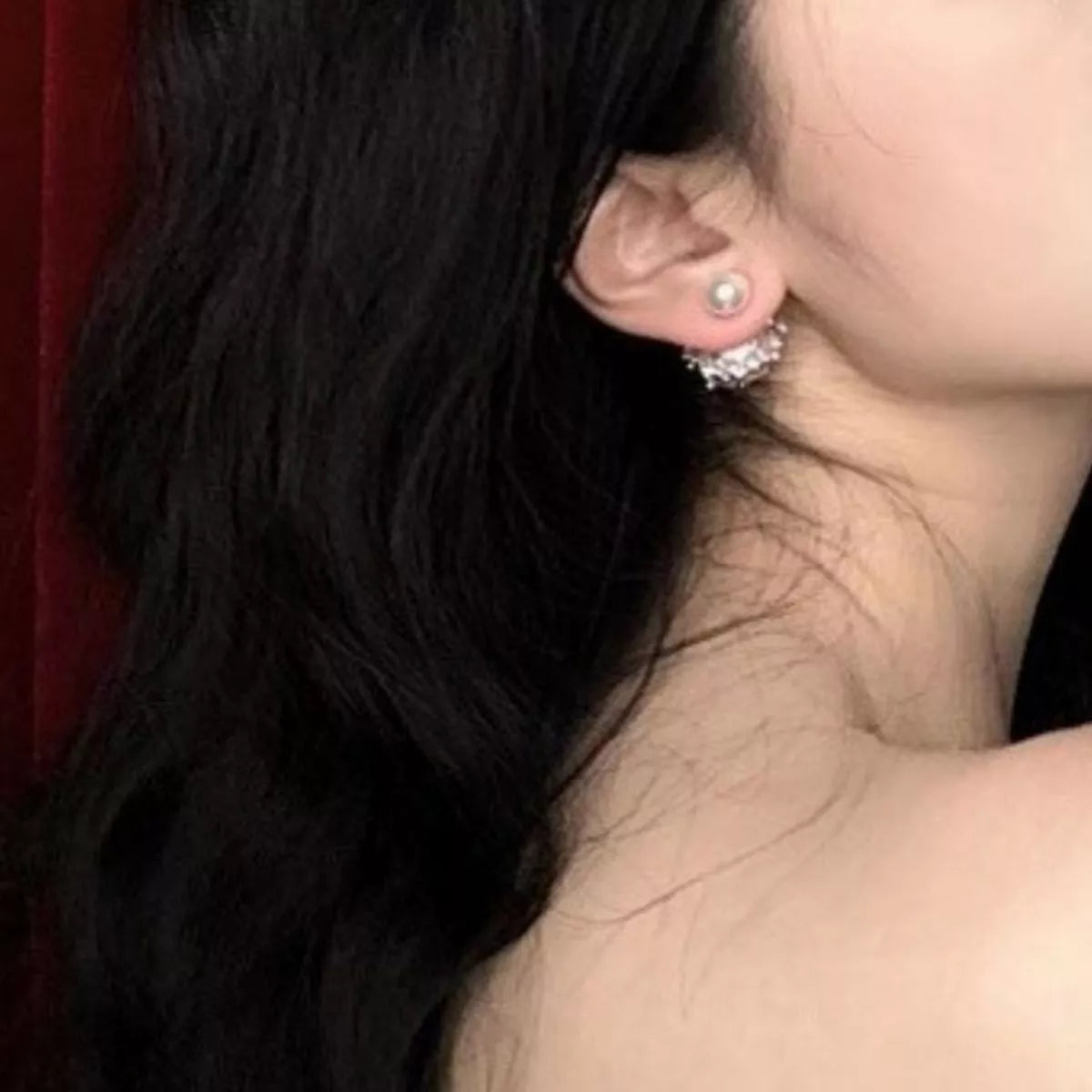 Pearl stud earrings shown at an angle