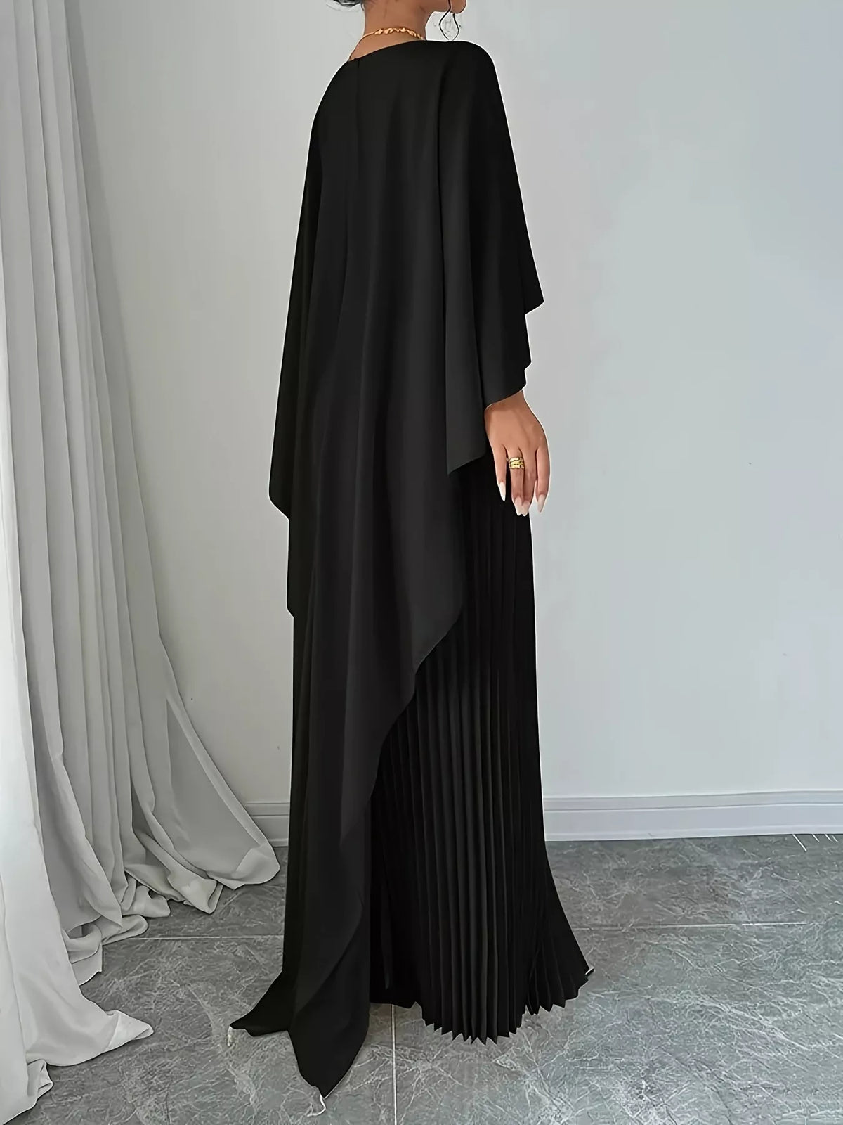 cape sleeve pleated maxi dress seated pose