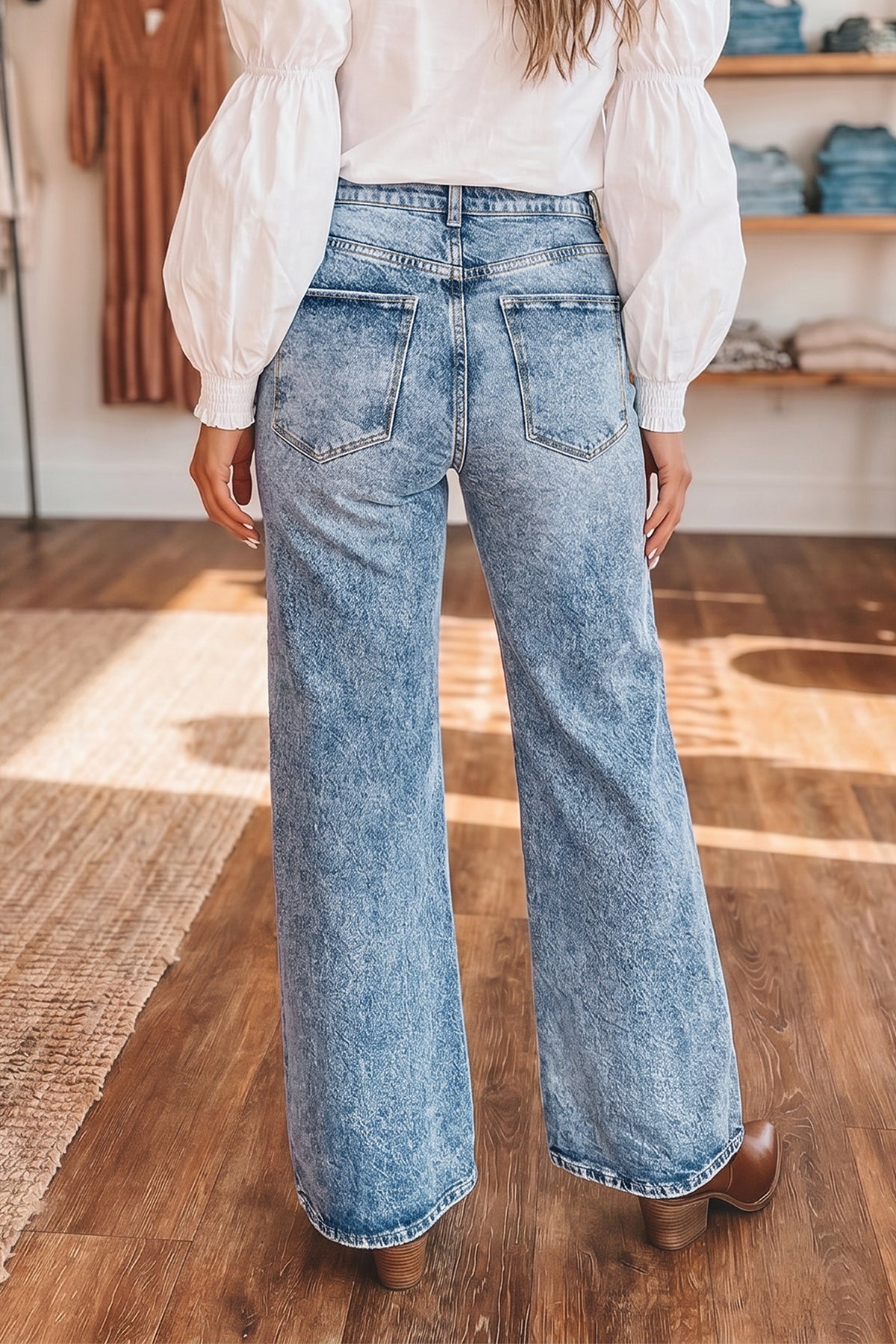 Back view of blue acid wash flare jeans showing rear pockets and wide leg