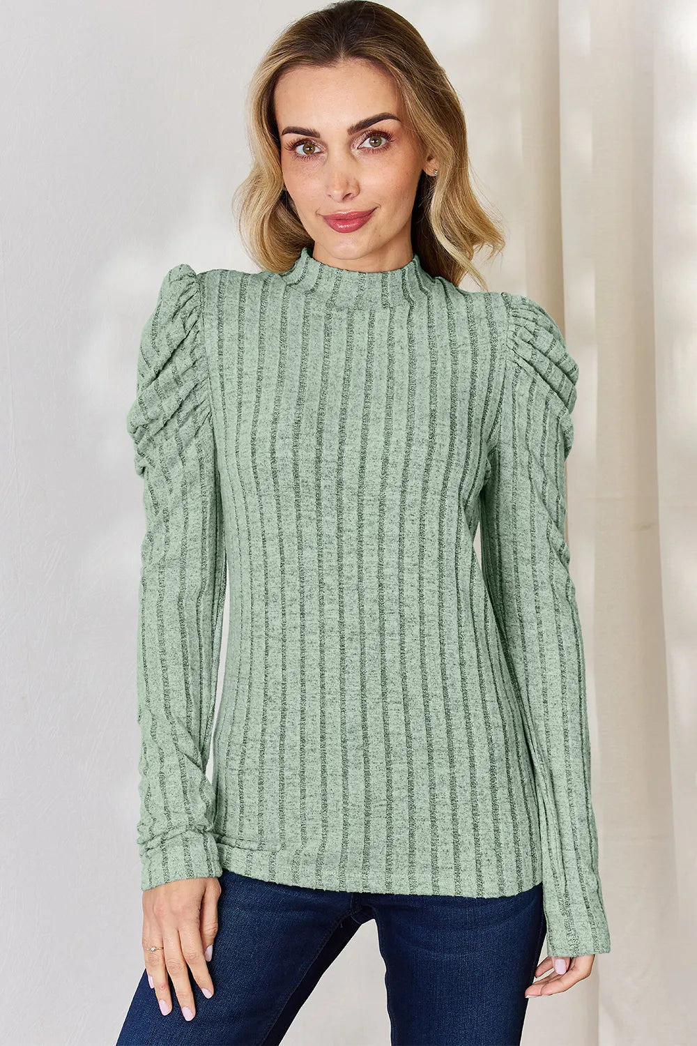 Mock neck top styled with trousers