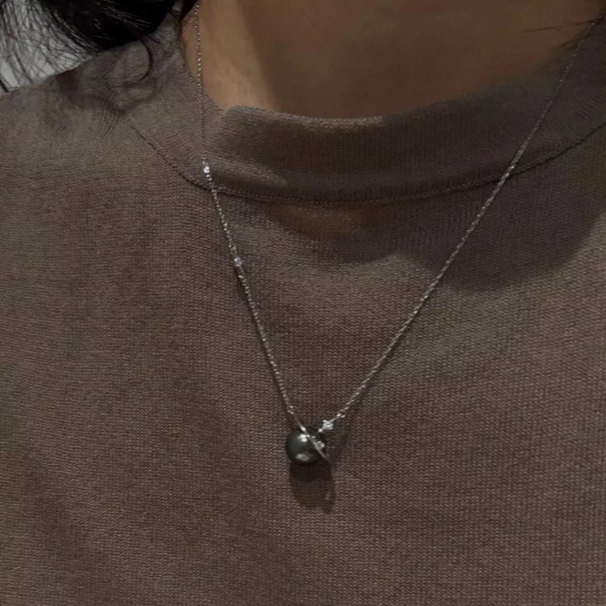 Planet pearl pendant necklace on sterling silver chain side view