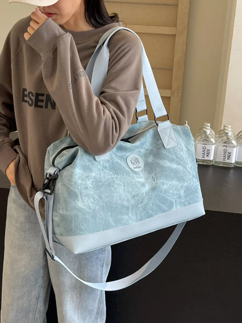 Blue PU leather duffel with strap front view