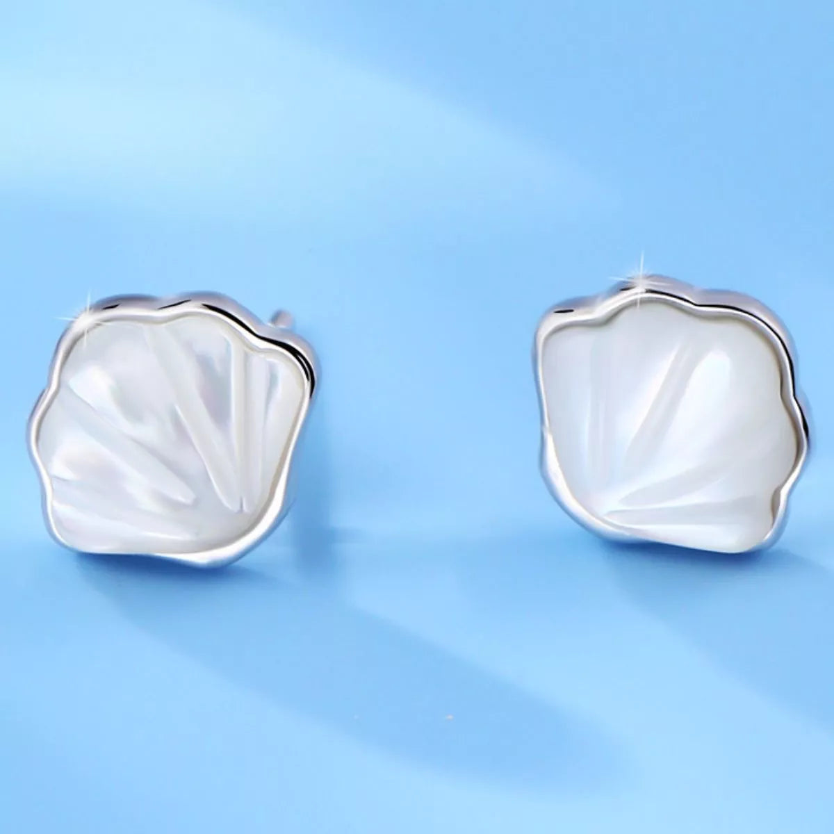 Silver shell studs shown to indicate their small scale