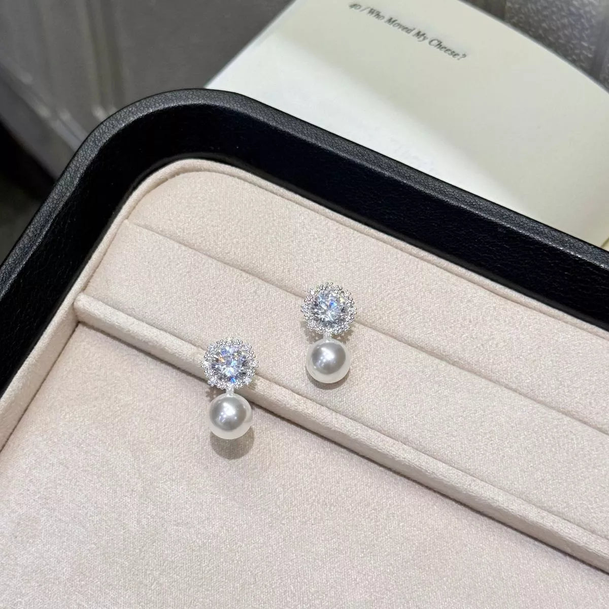 Silver tone drop earrings close up