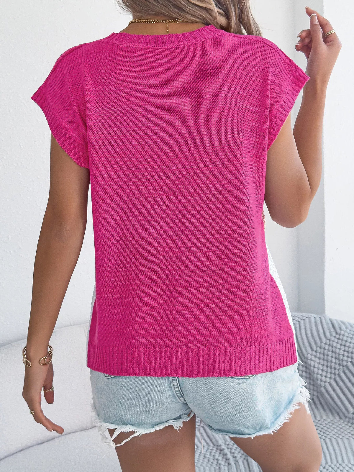 Model wearing color block cable knit sweater