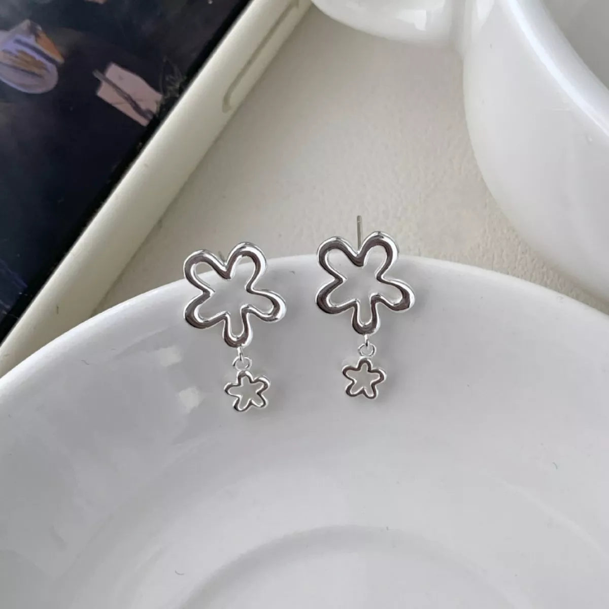 Flower drop earrings photographed together to show matching pair