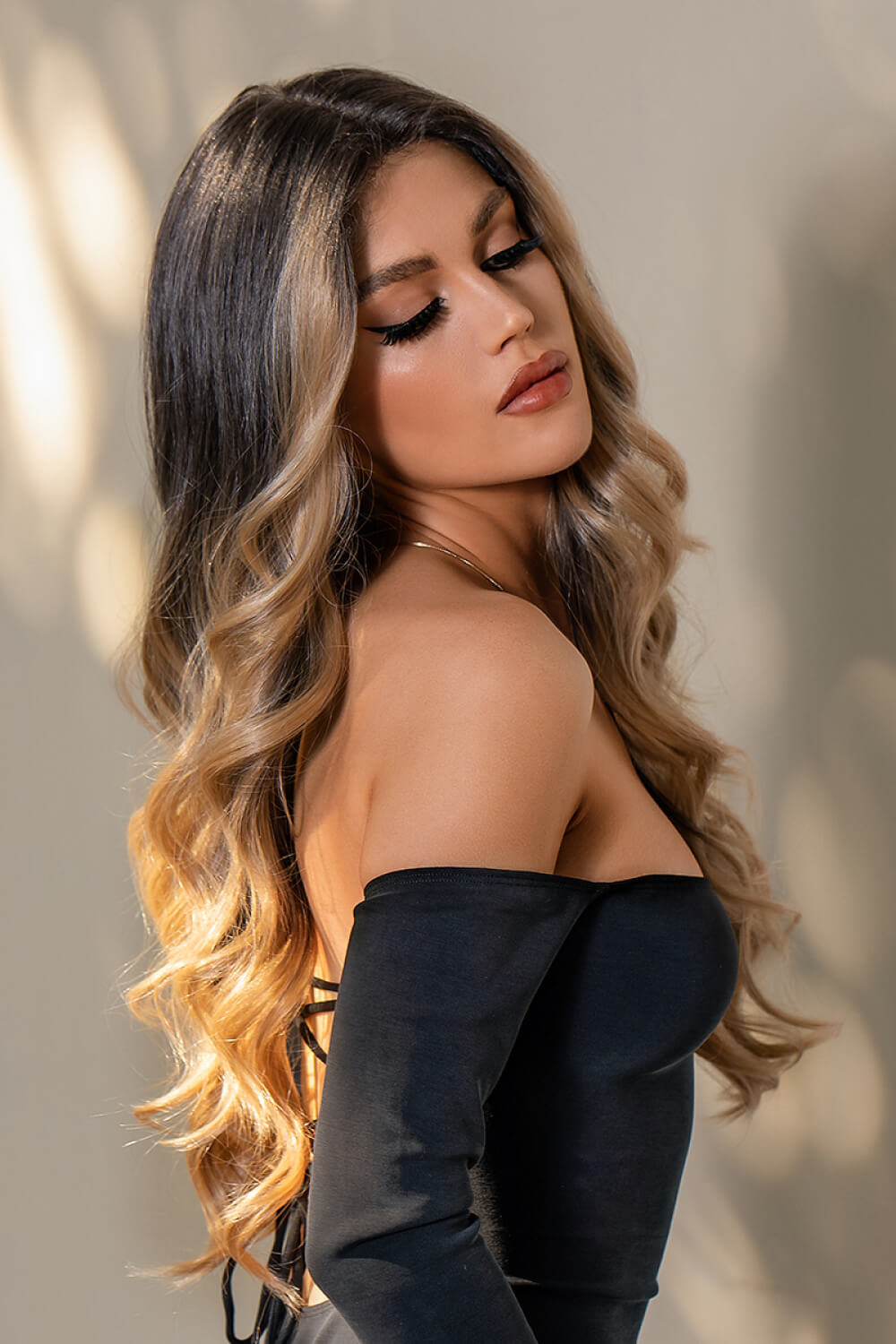 Model wearing brown caramel balayage wavy wig