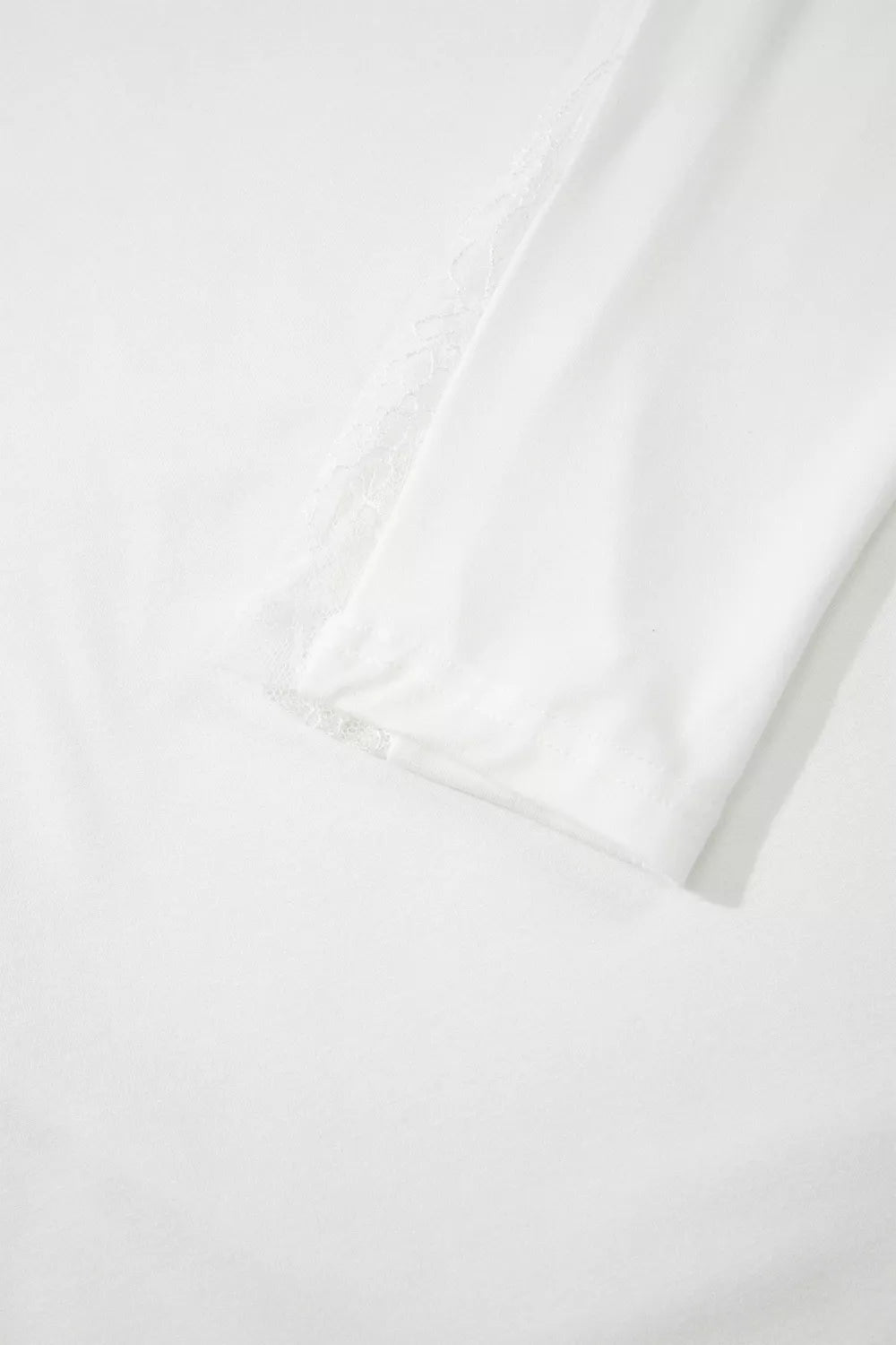 White lace patchwork top shown tucked into a skirt