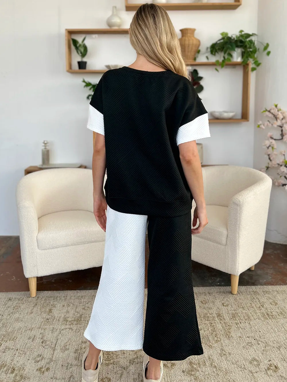 Seated view showing the drape of the wide leg pants