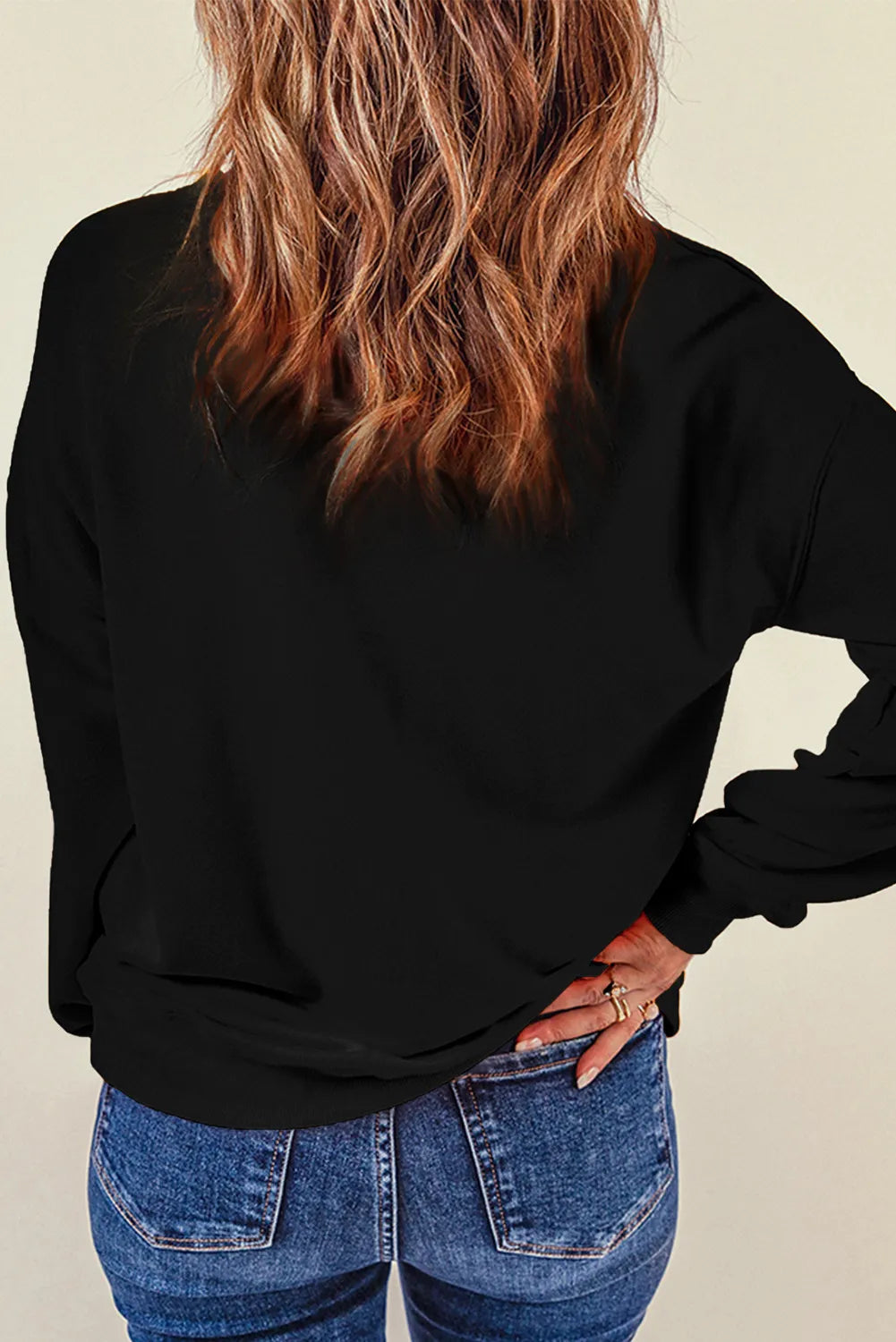 Side view of black long sleeve sweatshirt