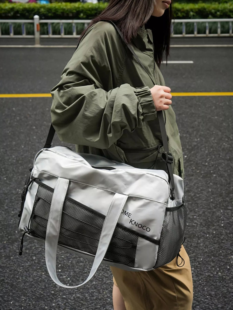 Silver duffel bag with mesh pockets front view