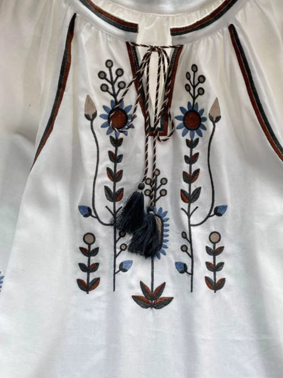 Polyester embroidered tie neck blouse, three quarter angle