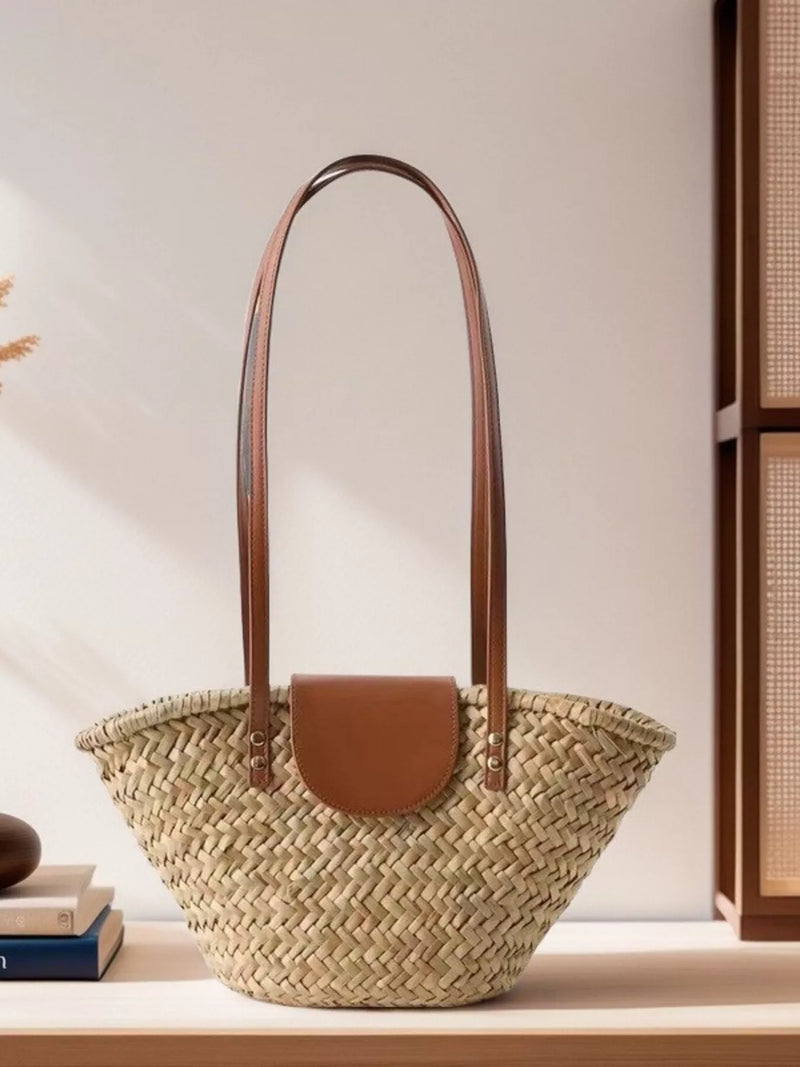 Khaki woven straw shoulder bag with leather accents front view