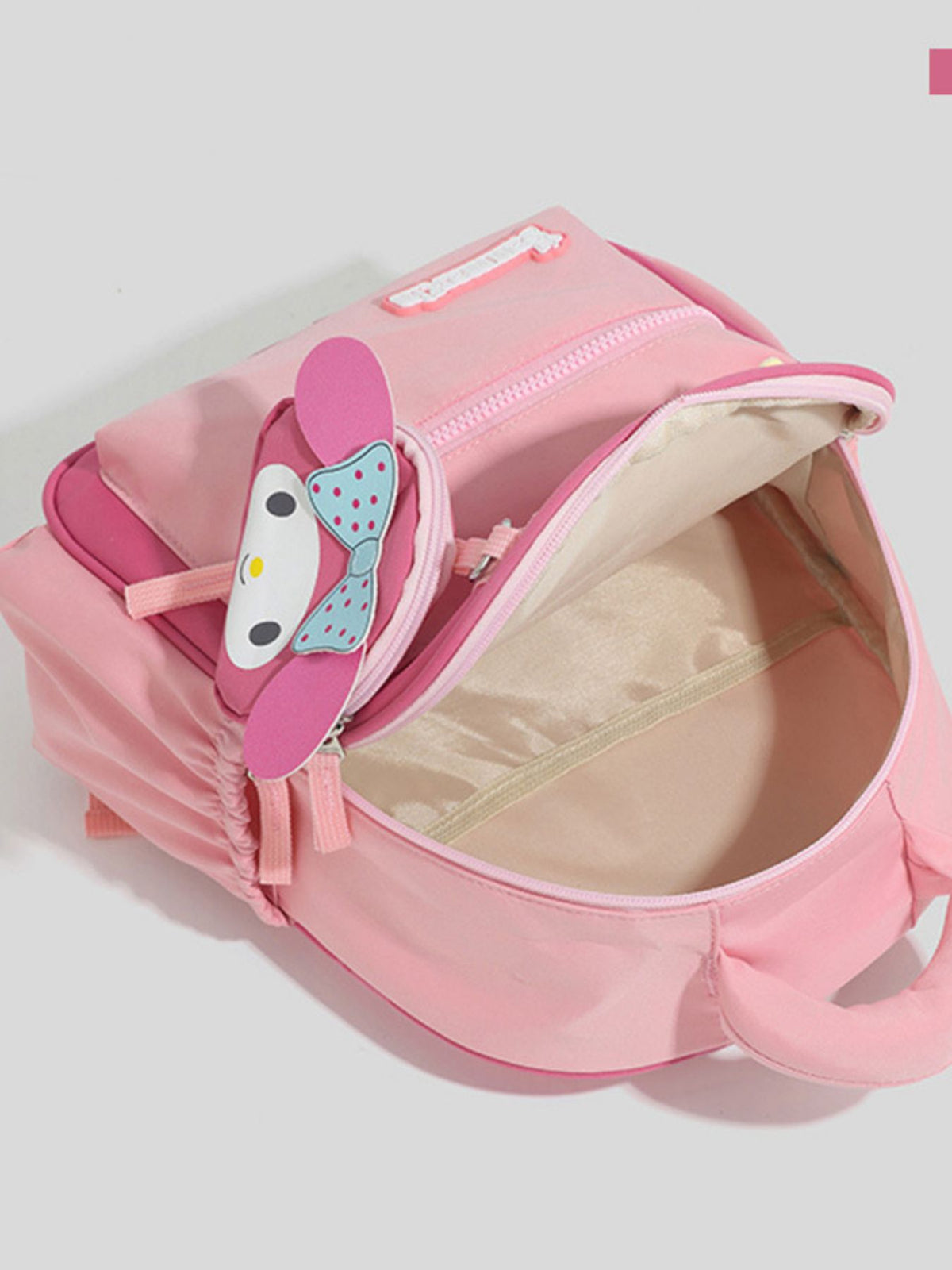pink cartoon nylon backpack worn on the shoulders