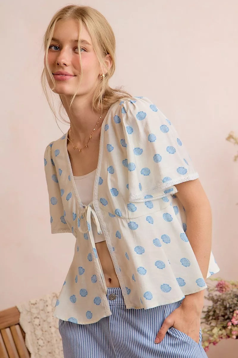 Ivory and blue shell print tie front flutter sleeve blouse detail view