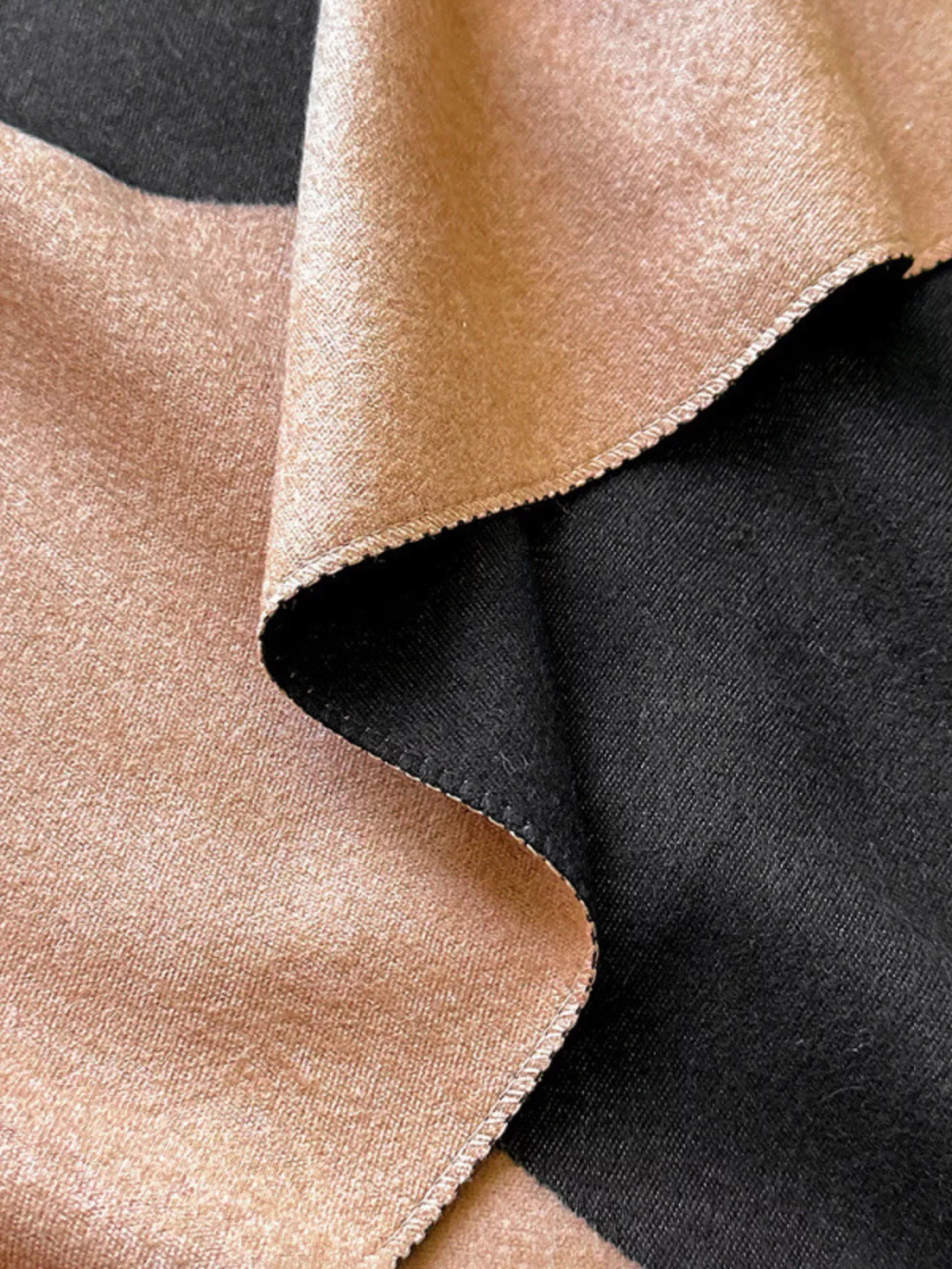 Raw hem scarf shown in soft natural light