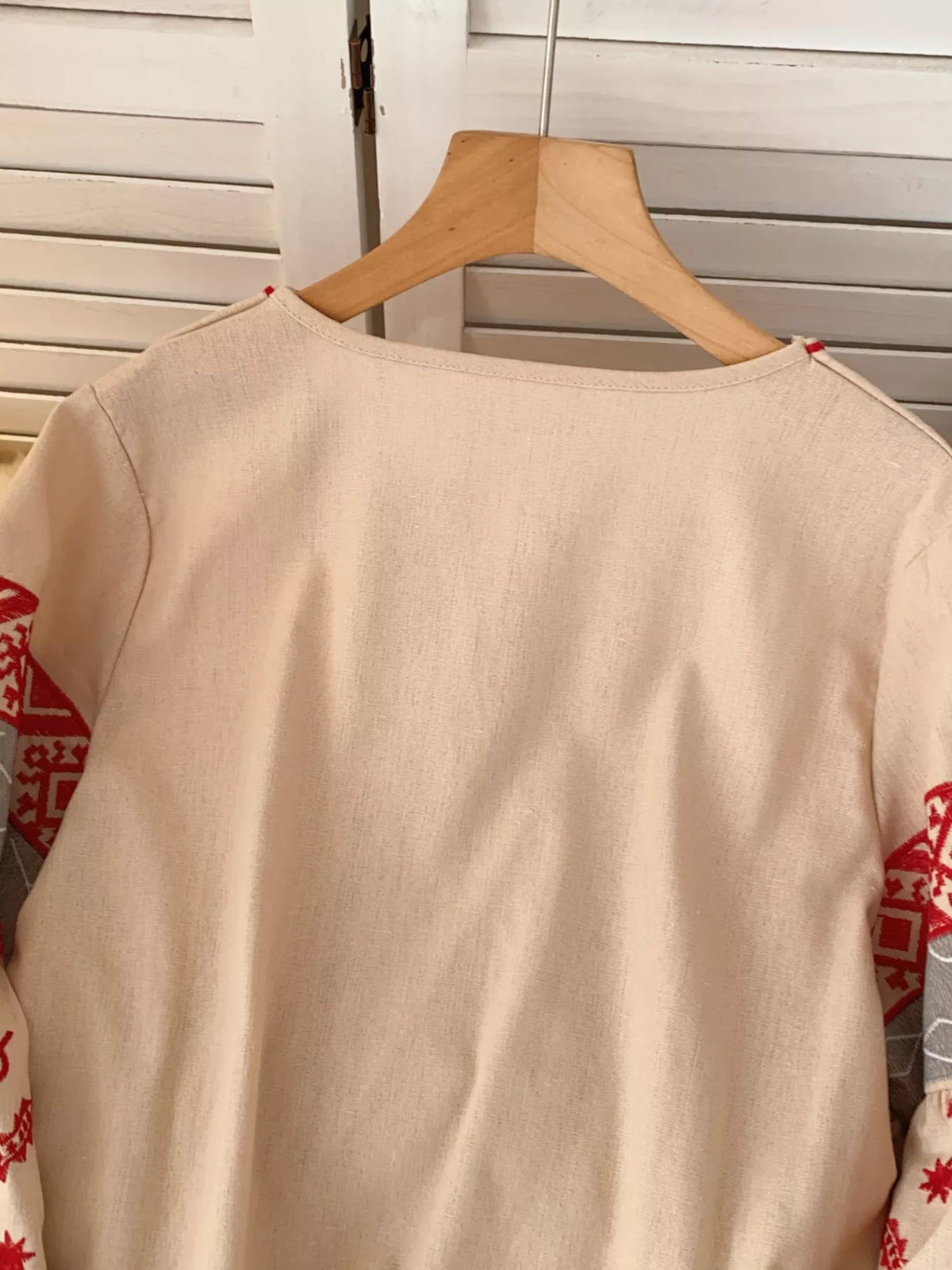 Embroidered tie neck blouse on model
