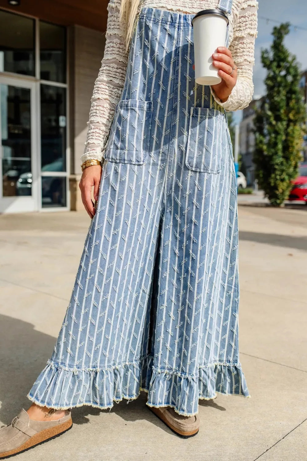 Striped overalls distressed detail close up