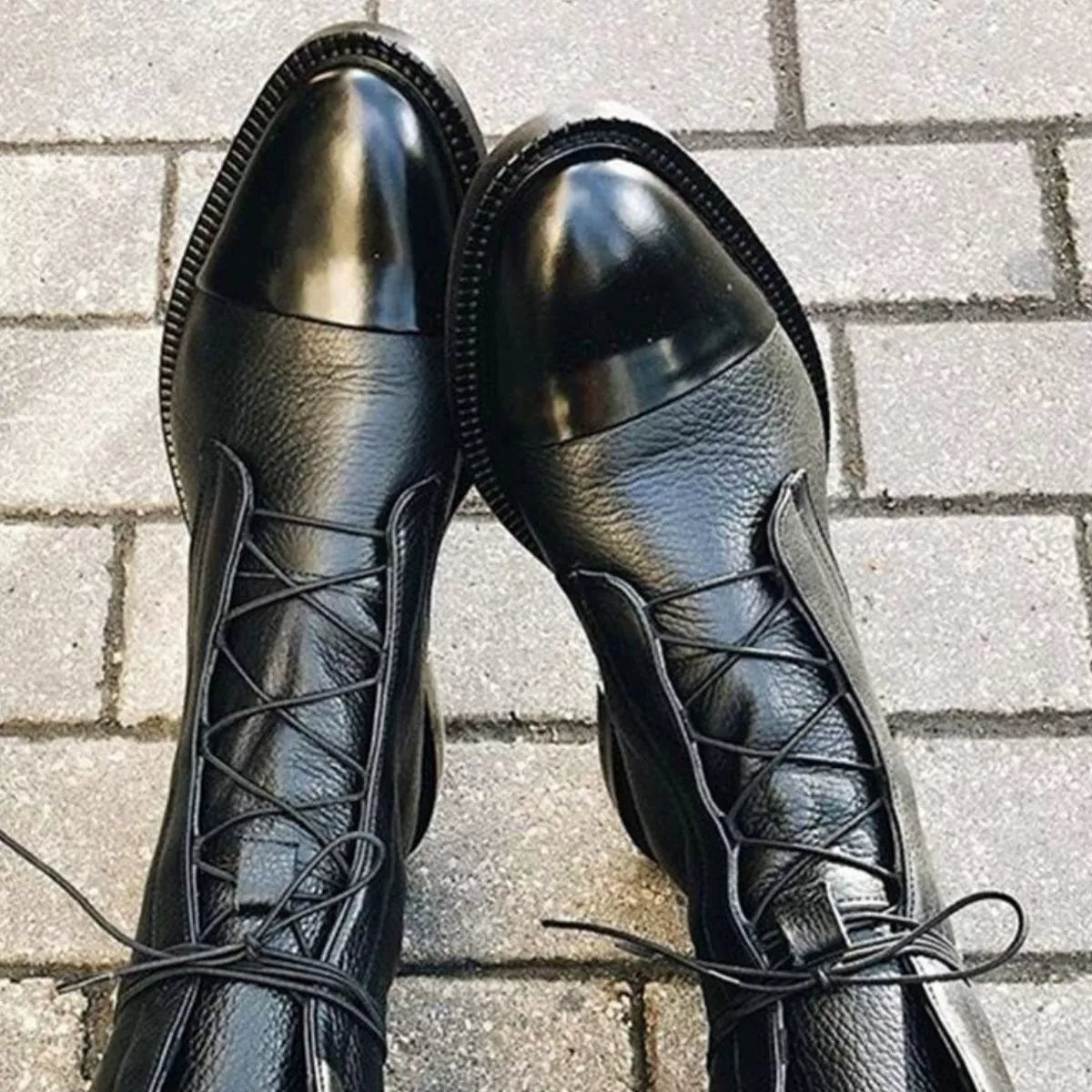 Black lace up leather boots side profile view