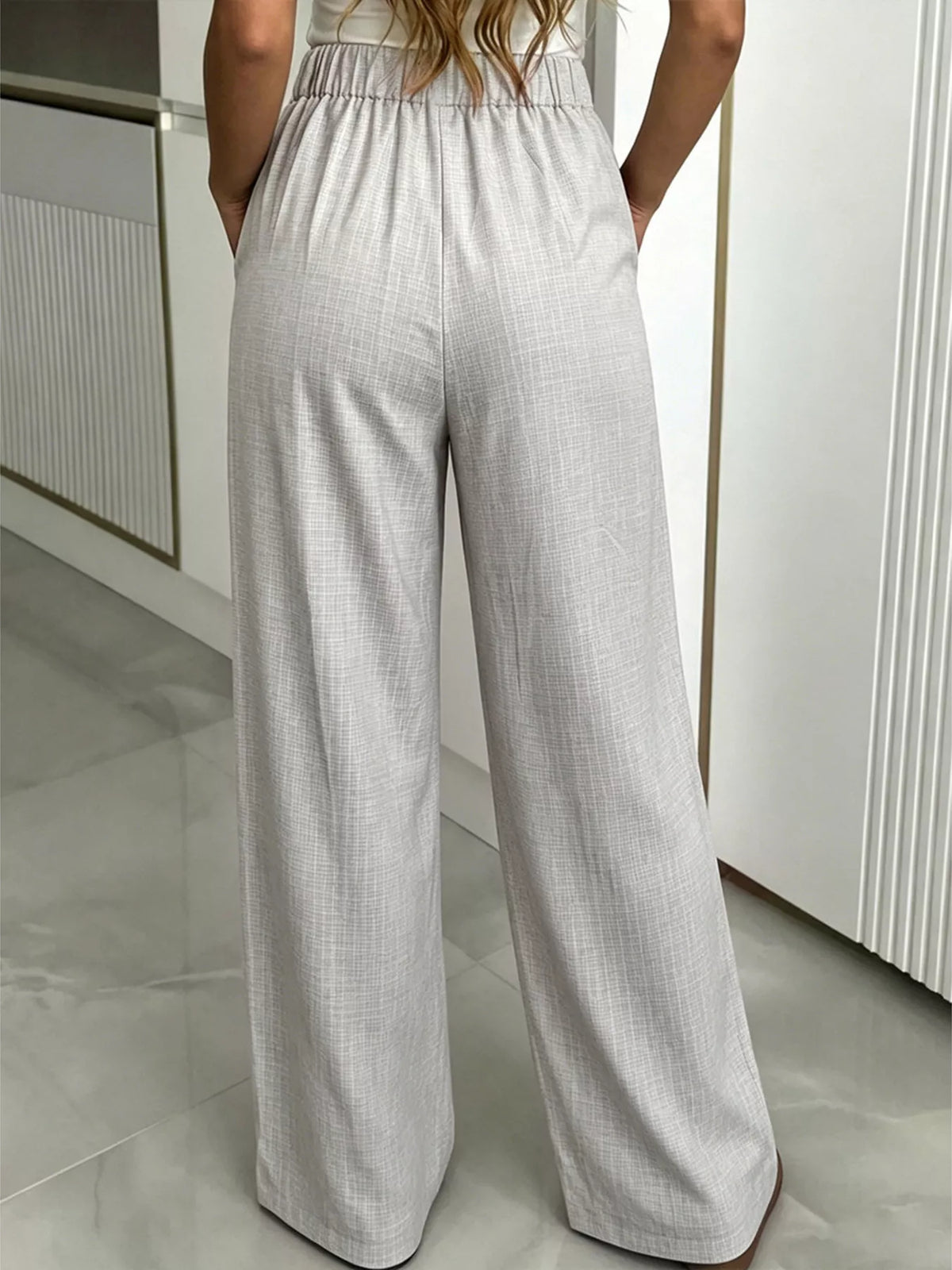 Close up of the pleats and waistband on the pants