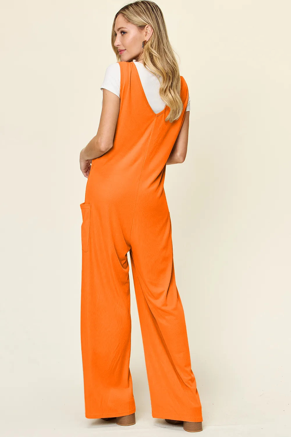 Side profile of the sleeveless jumpsuit with pockets