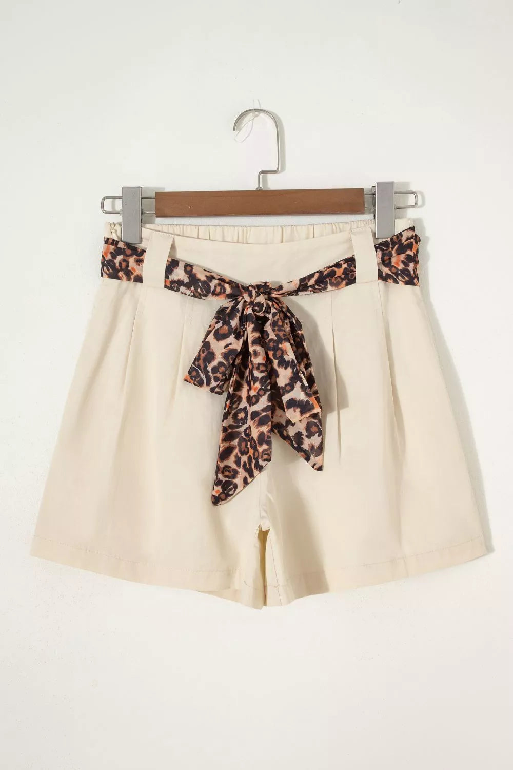 Beige high waisted pleated shorts full length view