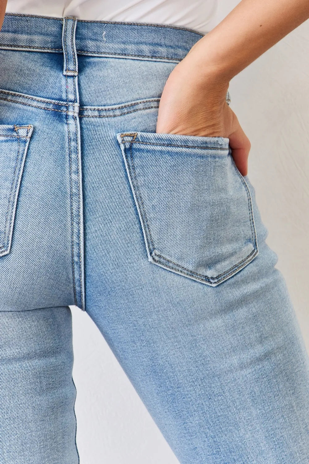 Full length styling of blue bootcut jeans