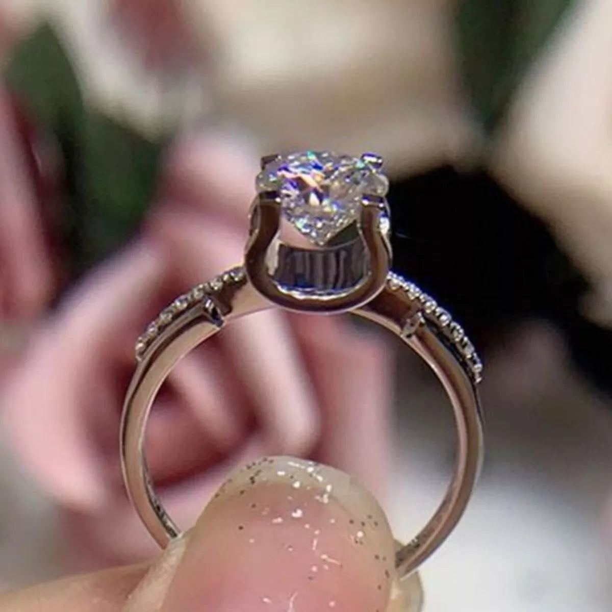 Moissanite ring shown at an angle to catch the light