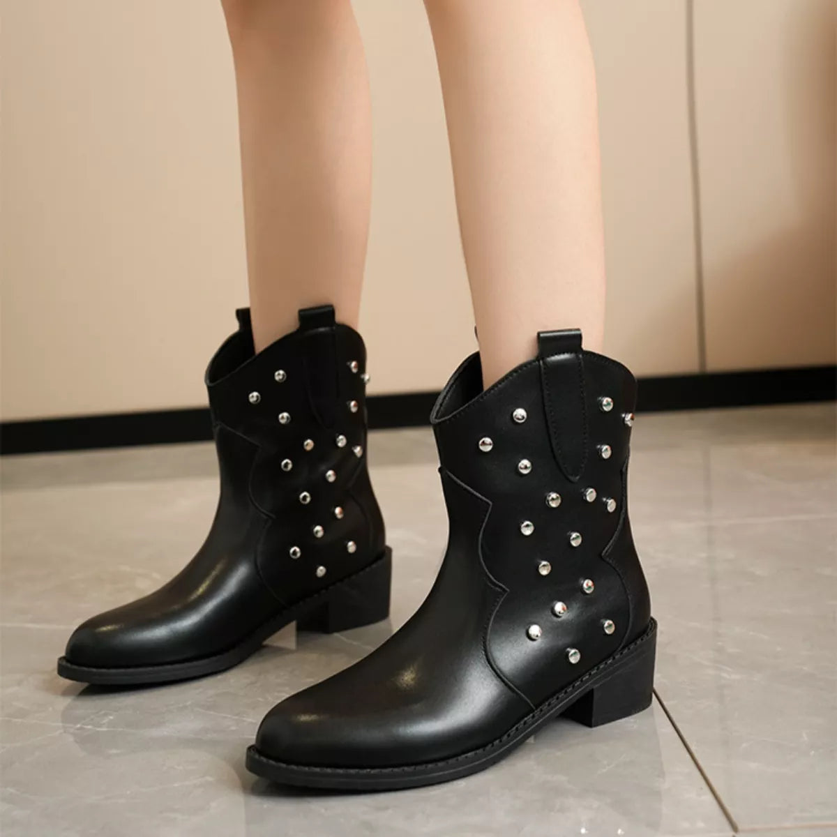 Studded western ankle boots angled view