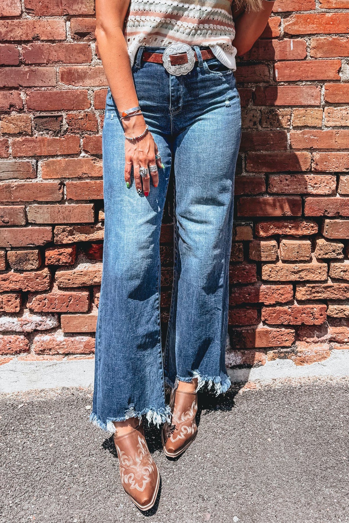 Blue frayed hem flare jeans waistband and pocket detail