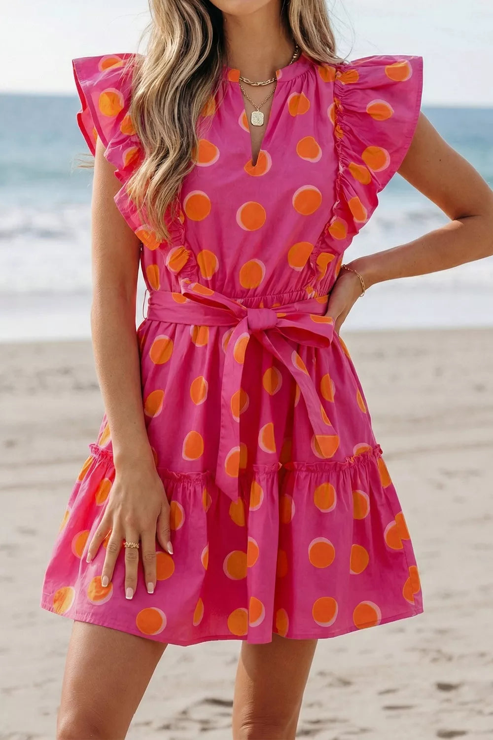 Back view of belted polka dot mini dress