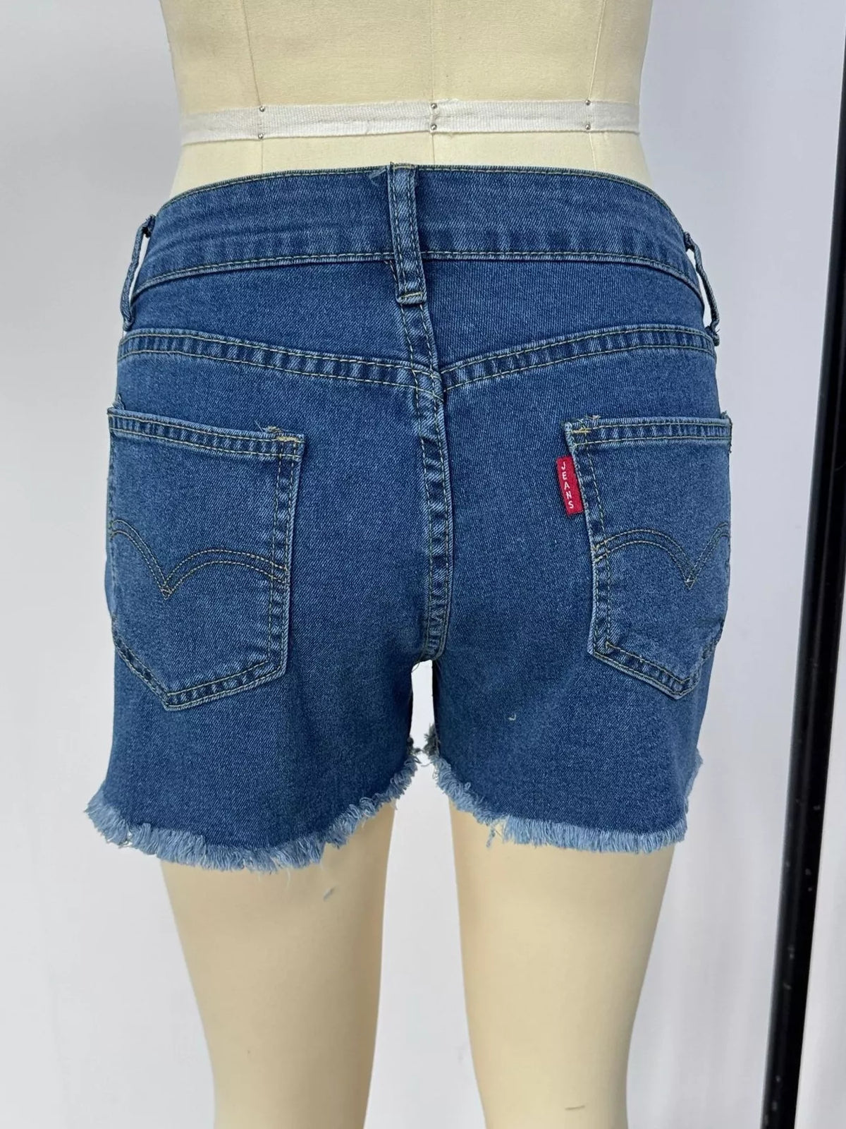 Raw hem denim shorts flat lay view