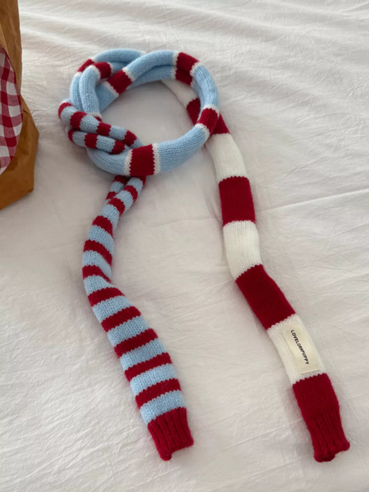 Striped scarf looped for extra warmth