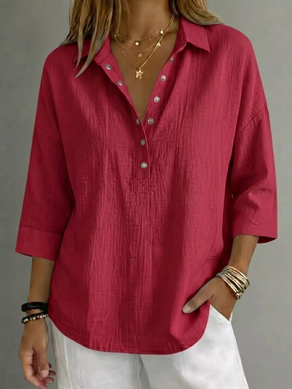 Snap down blouse in black shown on a model