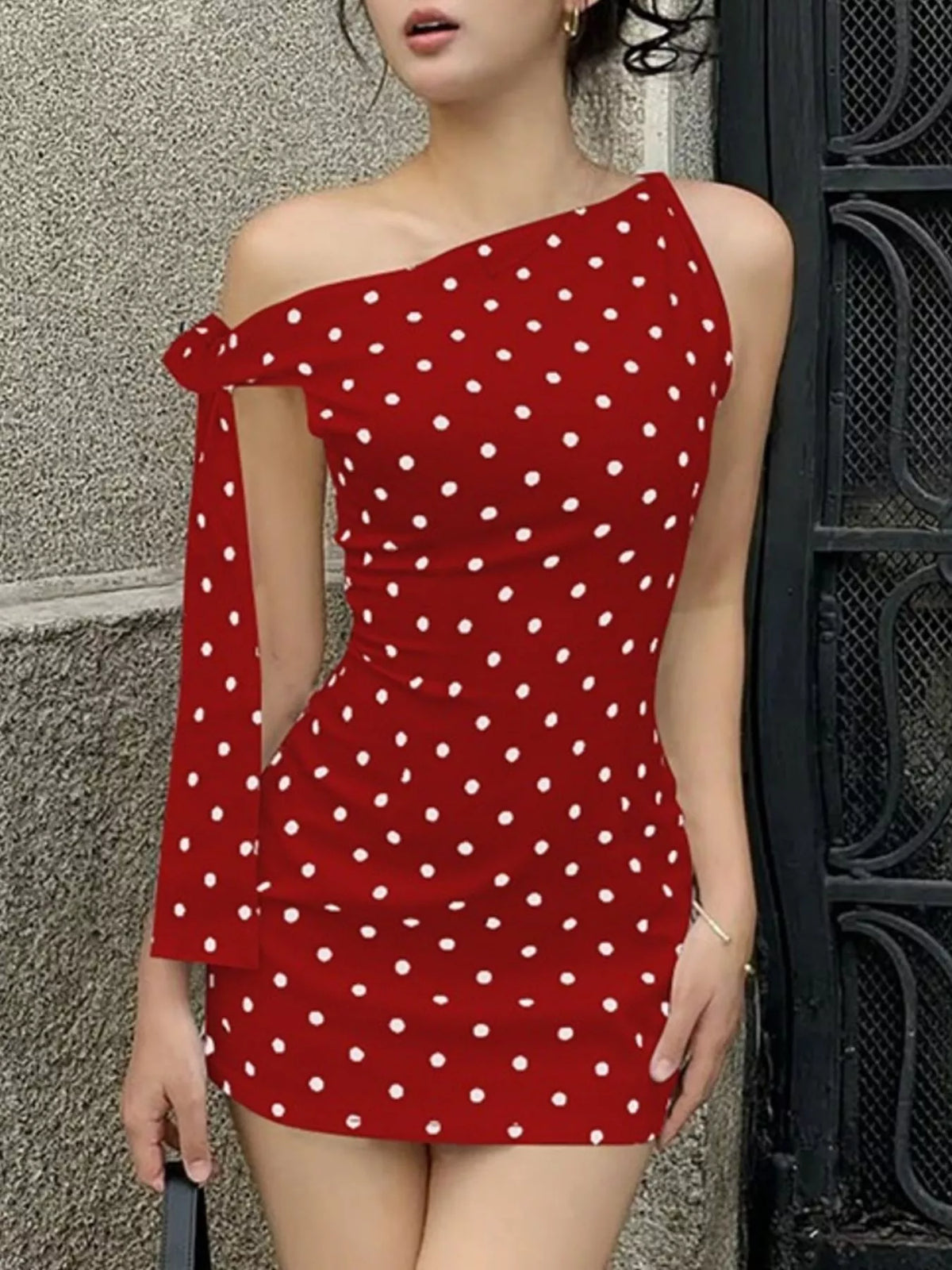 Sleeveless polka dot mini dress laid flat, full garment view