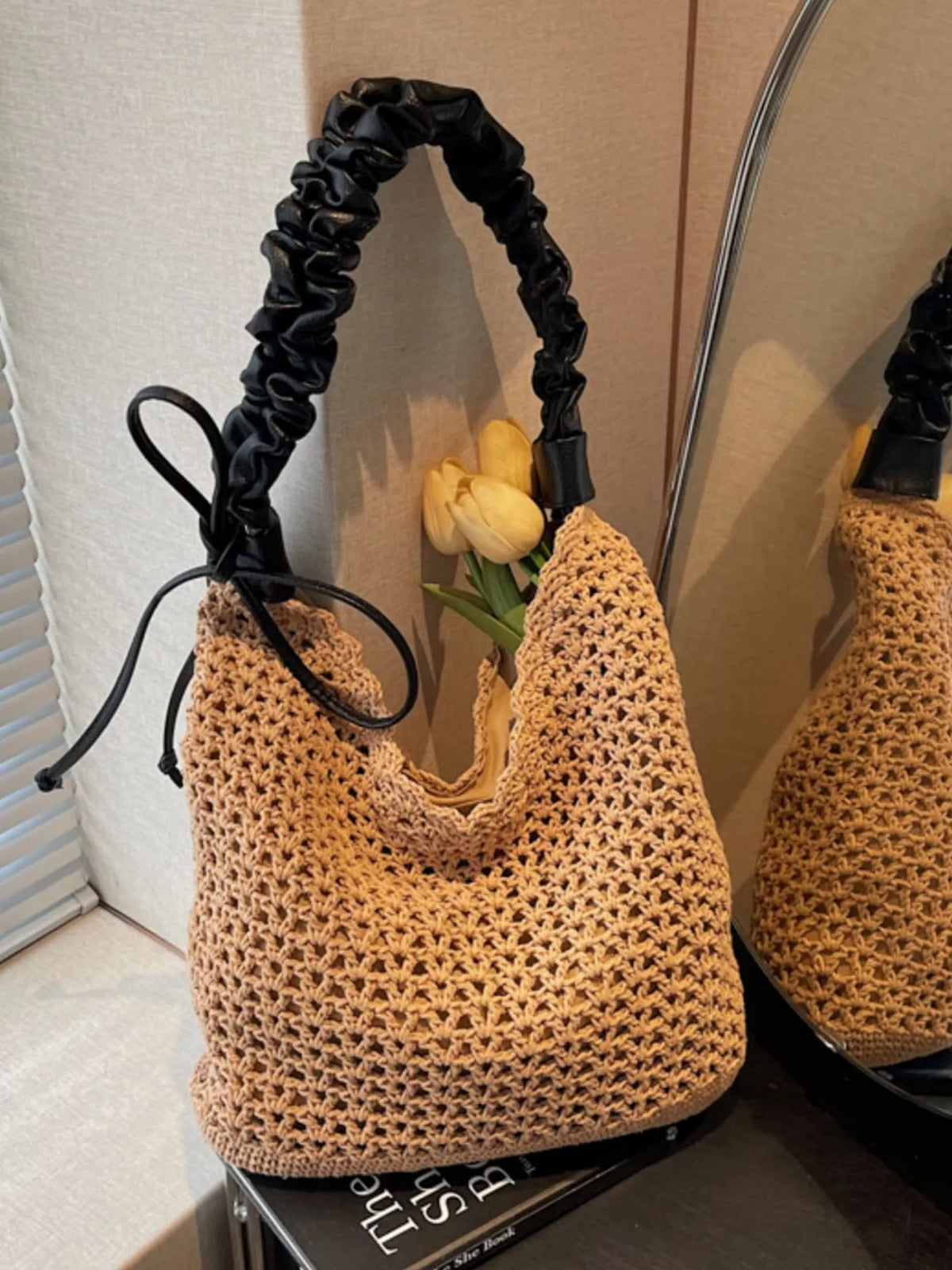 Woven straw shoulder bag shown from the side