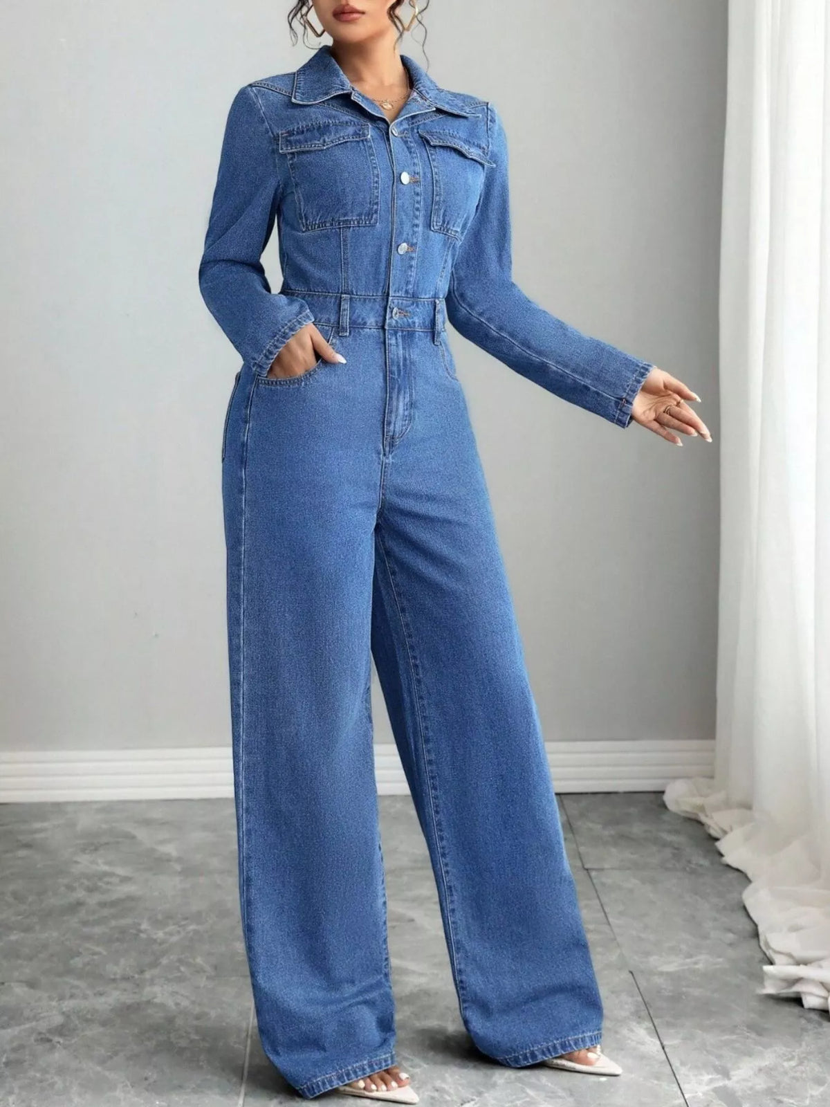 Blue denim jumpsuit pocket and button detail