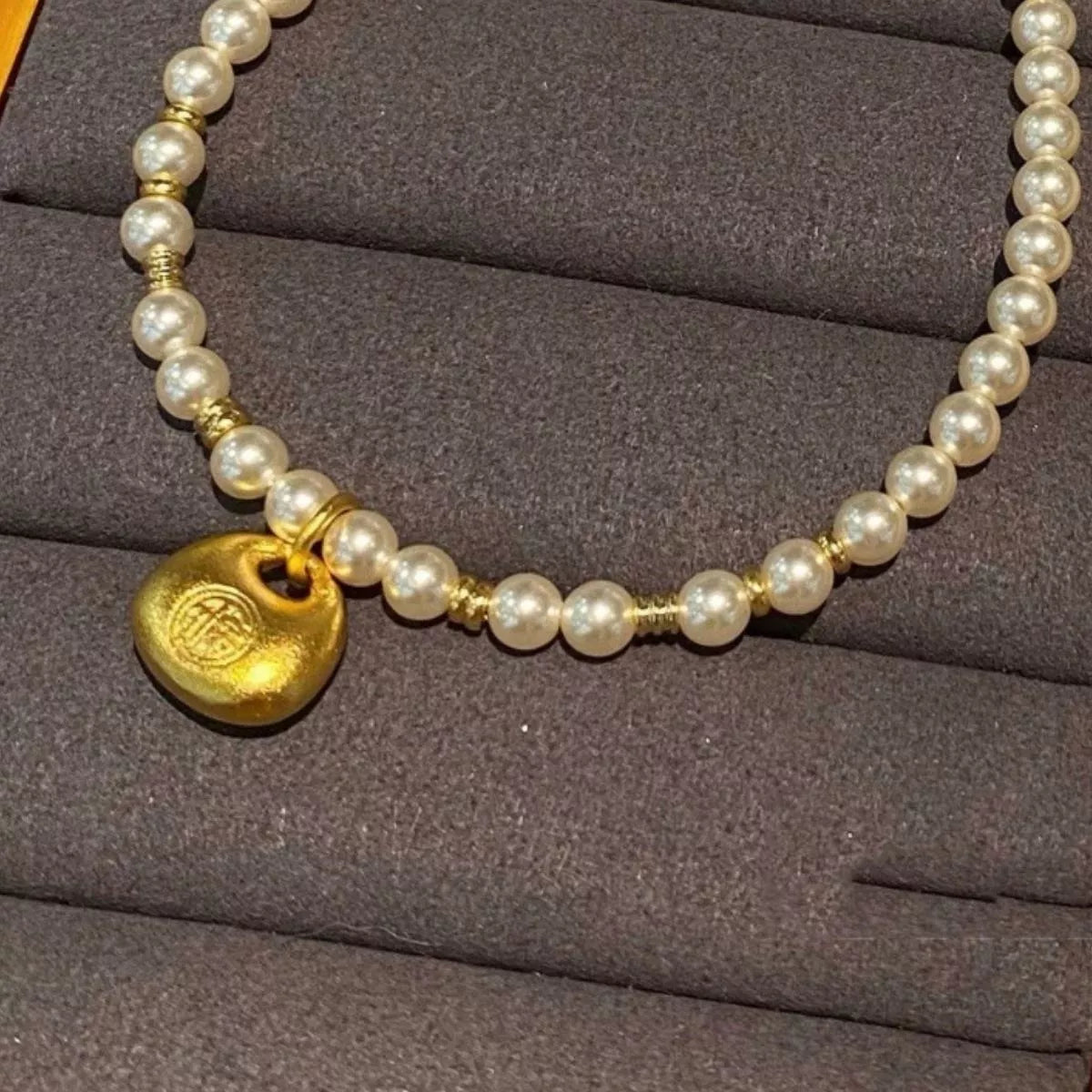pearl necklace with gold pendant angle view