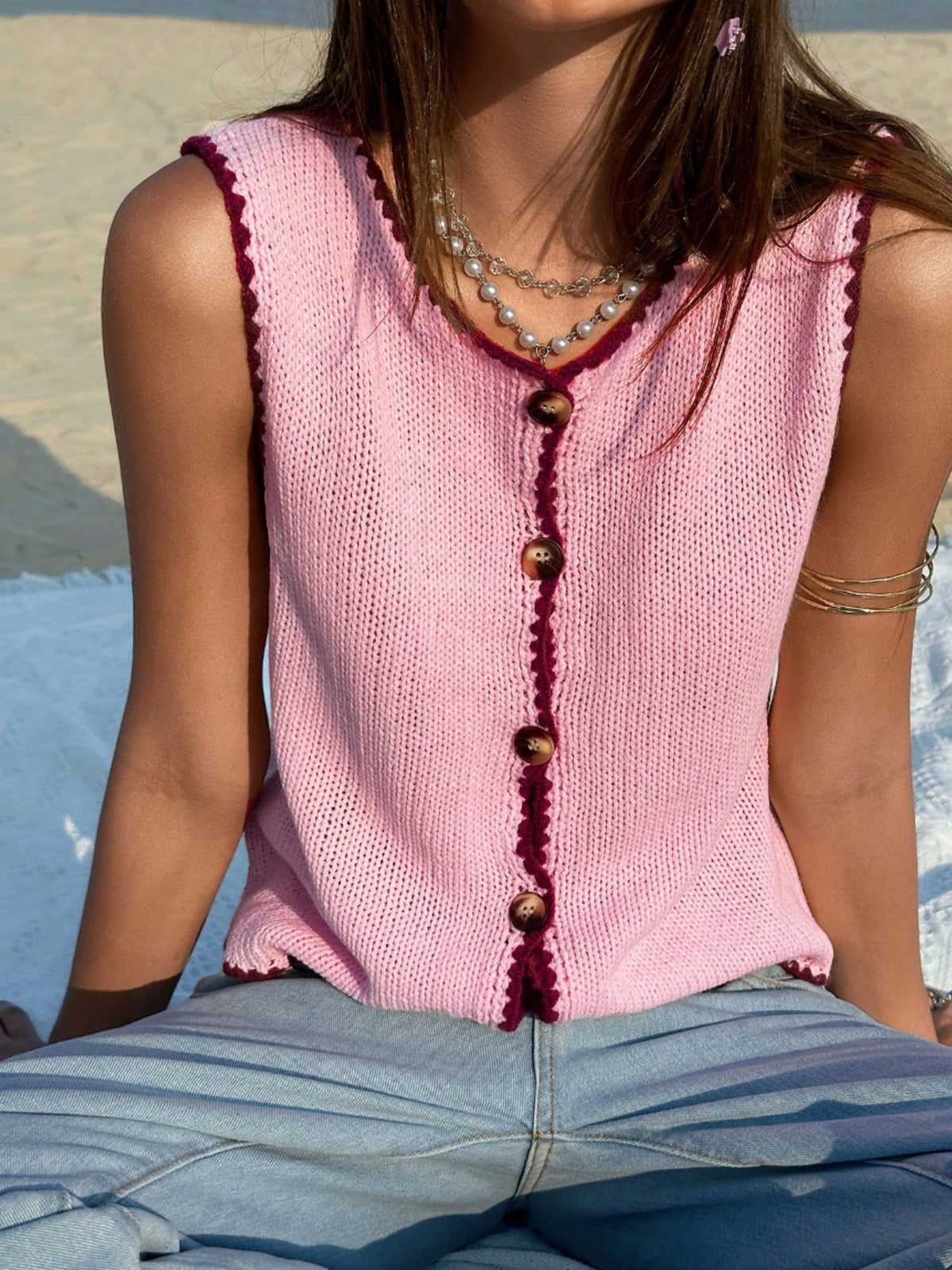 Pastel cropped knit vest styled with high waist jeans