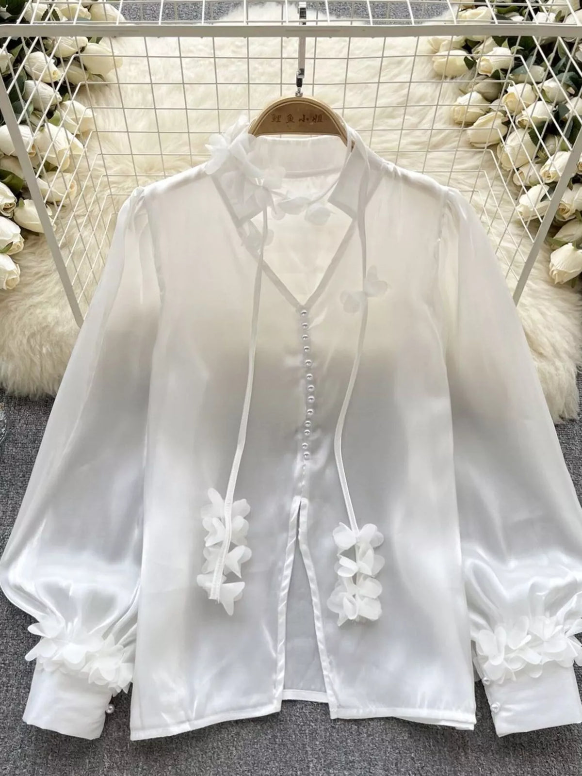 Apricot sheer floral shirt showing the button placket