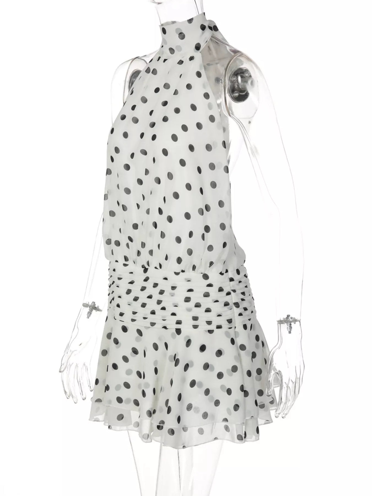Polka dot halter dress shown from a seated angle