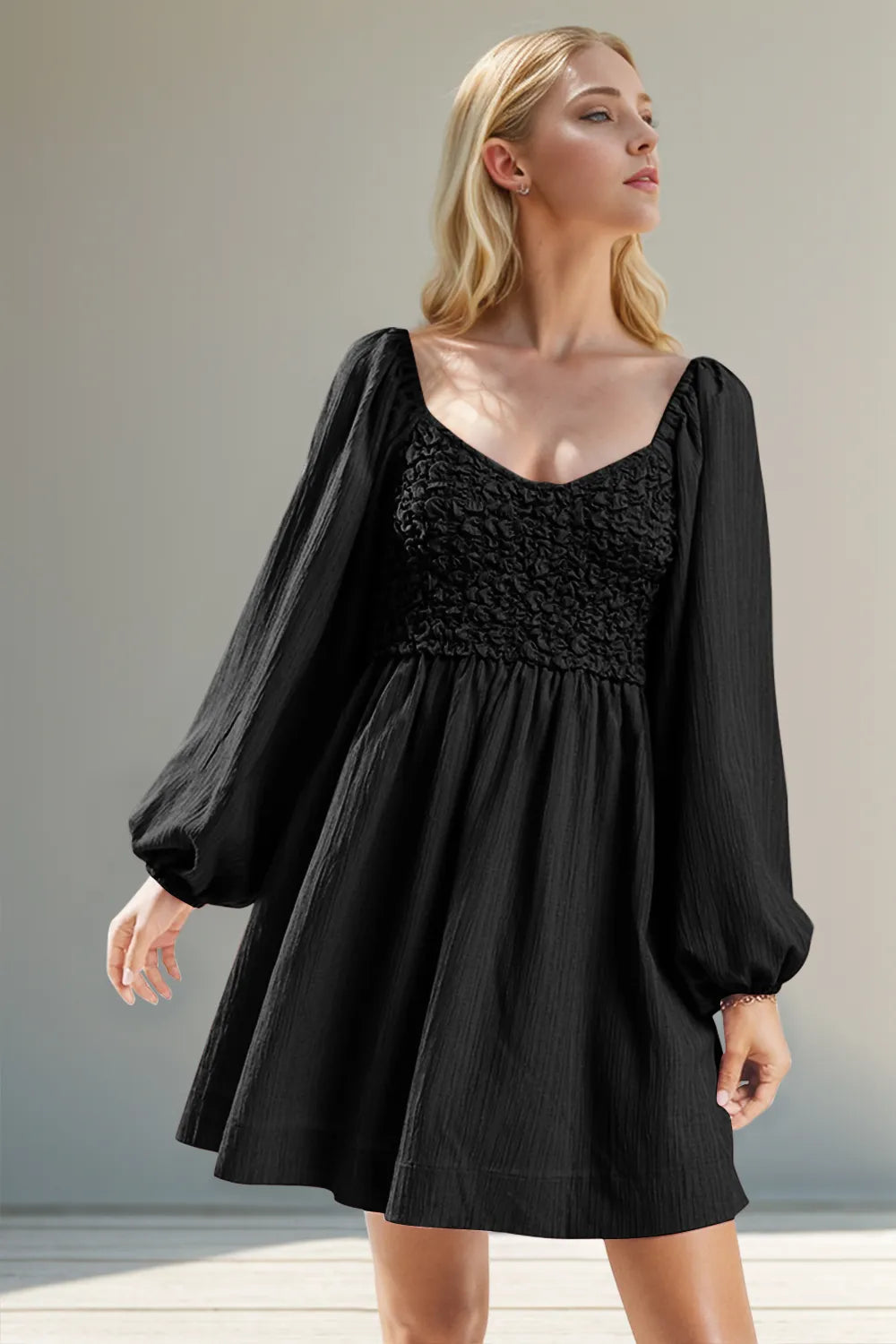 Black textured smocked balloon sleeve mini dress front view