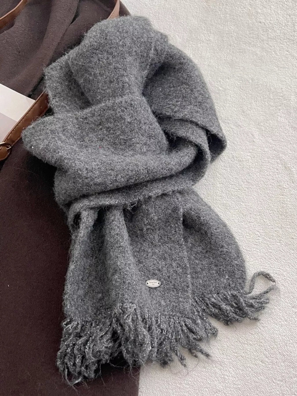 Close up of knit texture and fringe ends