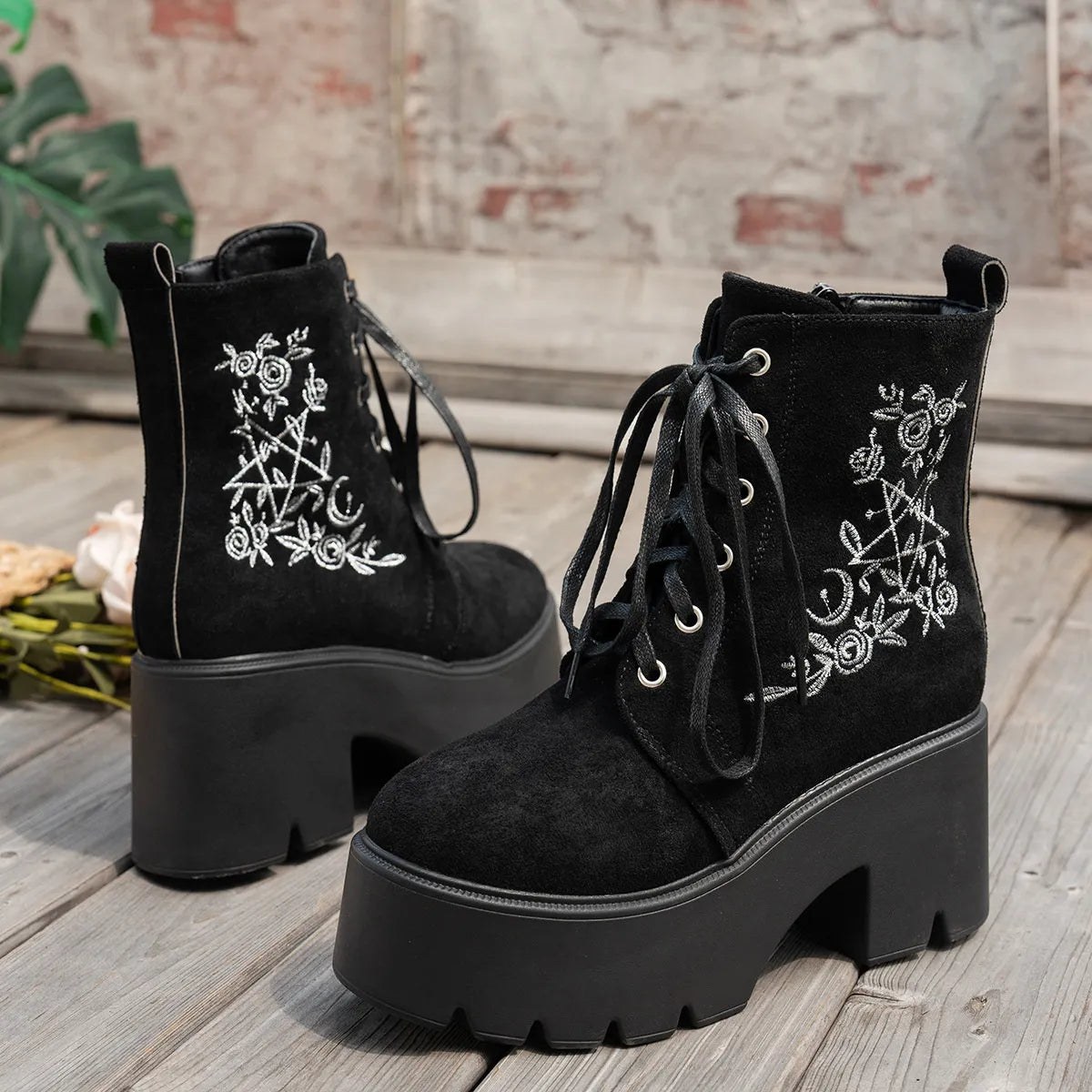 Floral embroidered platform combat boots in Black, front view