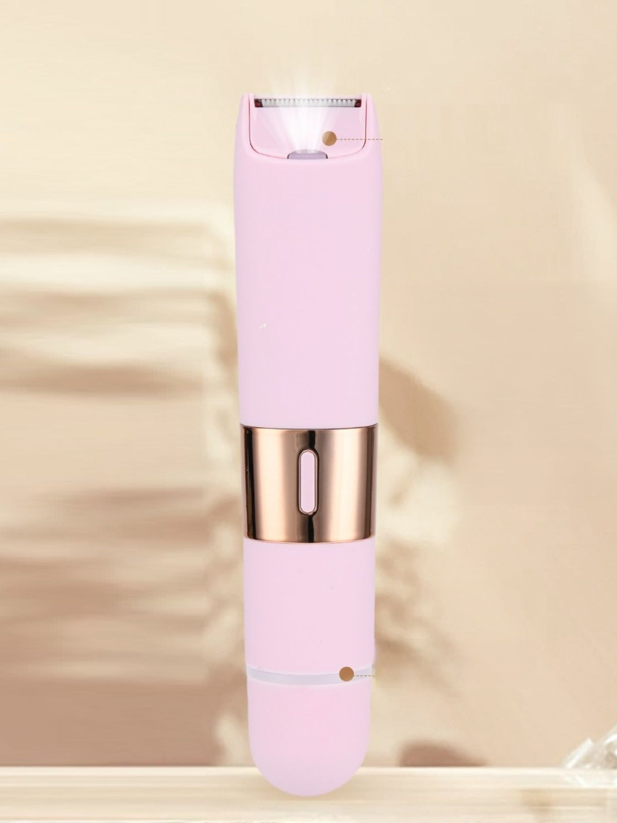 Epilator held in hand showing compact size