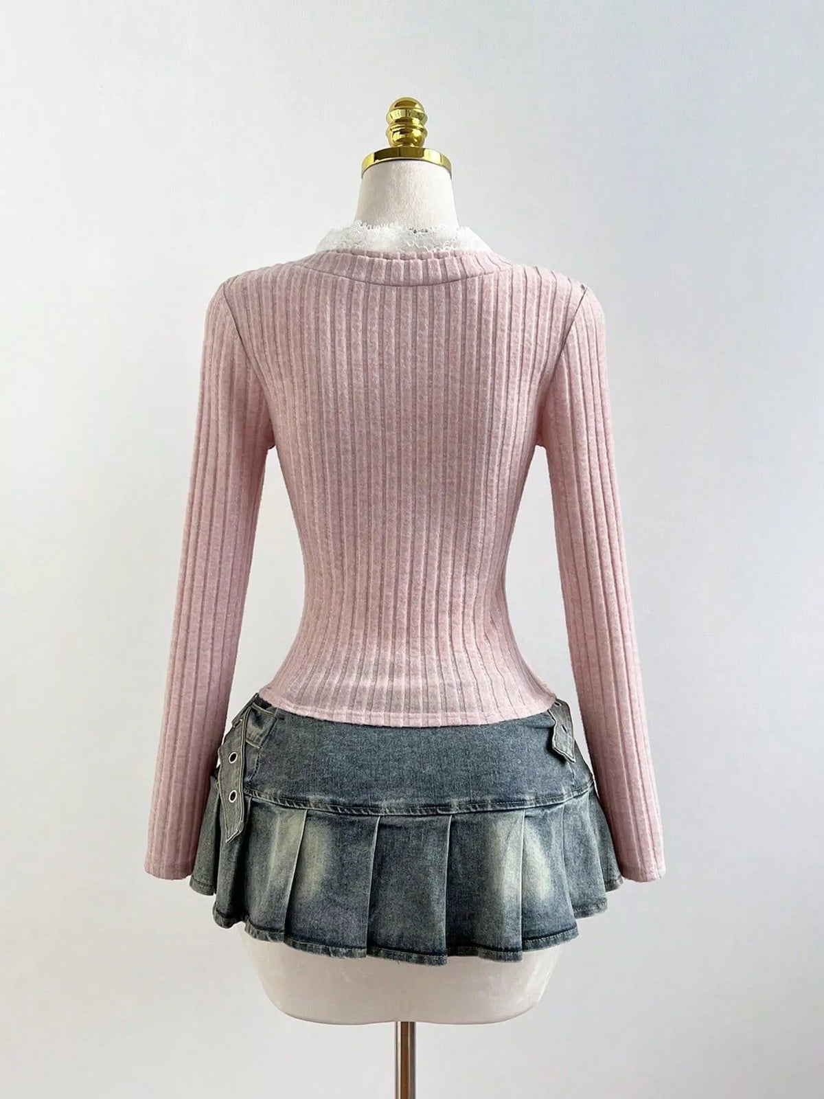 Fitted long sleeve knit top shown on a dress form