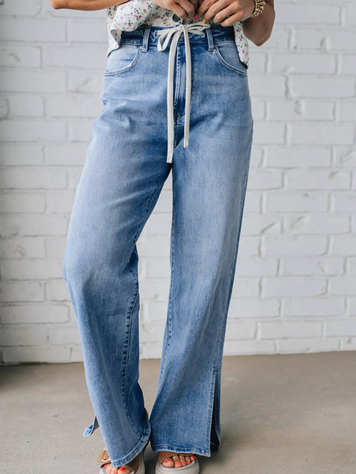Wide leg jeans showing front slit hem detail